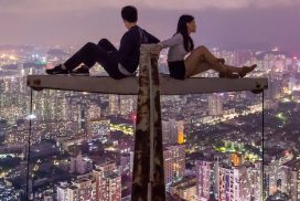 Lonely couple in a place with a great view of the city at night